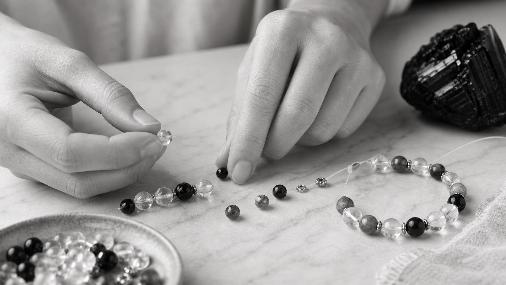 Hands arranging crystal beads in a studio